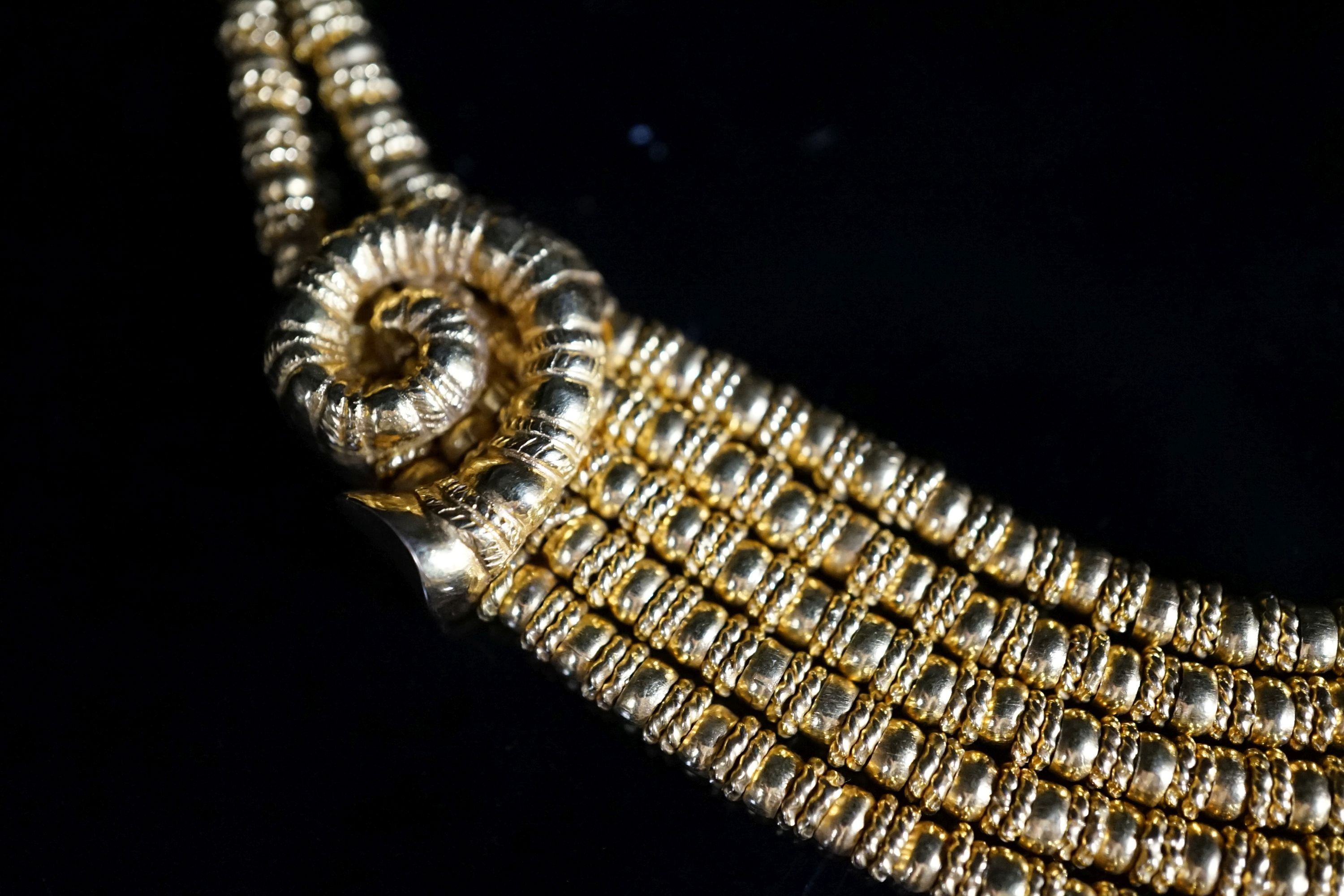 Ilias Lalaounis: a 750 yellow metal multi strand necklace, with shell motifs, 40cm, 146.3 grams, signed.